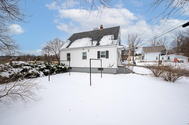 view of snow covered rear of property