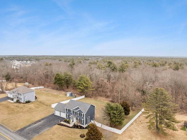 birds eye view of property featuring a view of trees