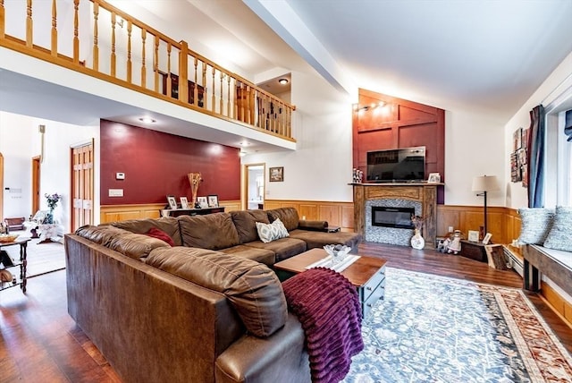 140 Sheffield Dr, Belchertown, MA 01007 - living area with wood finished floors, a wainscoted wall, and a glass covered fireplace