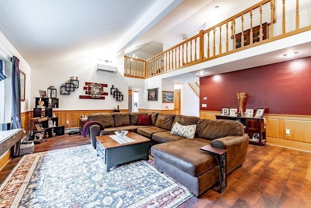 140 Sheffield Dr, Belchertown, MA 01007 - living room featuring wainscoting, wood finished floors, an AC wall unit, high vaulted ceiling, and baseboard heating