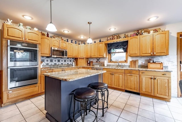 140 Sheffield Dr, Belchertown, MA 01007 - kitchen featuring appliances with stainless steel finishes, a sink, backsplash, light tile patterned flooring, and light stone counters