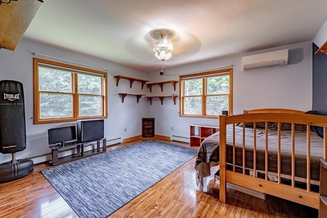 140 Sheffield Dr, Belchertown, MA 01007 - bedroom with a wall unit AC, baseboard heating, wood finished floors, and baseboards