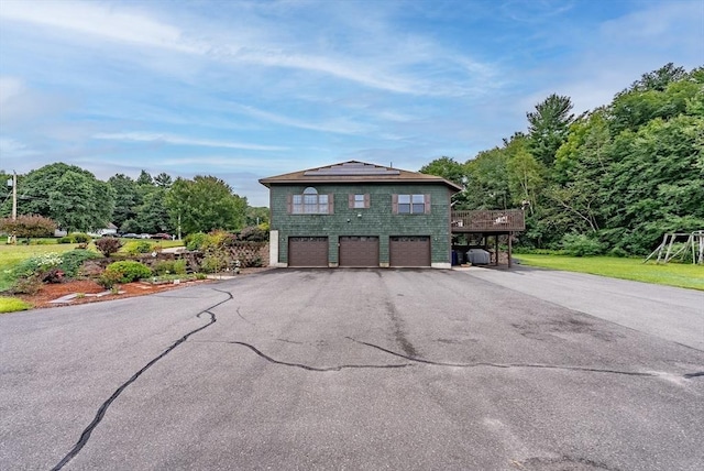 140 Sheffield Dr, Belchertown, MA 01007 - view of front of house featuring a garage, a wooden deck, and asphalt driveway