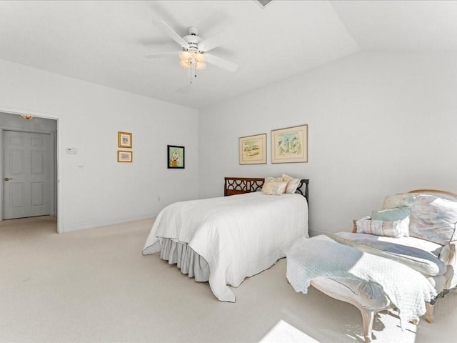 bedroom featuring baseboards, light carpet, a ceiling fan, and vaulted ceiling