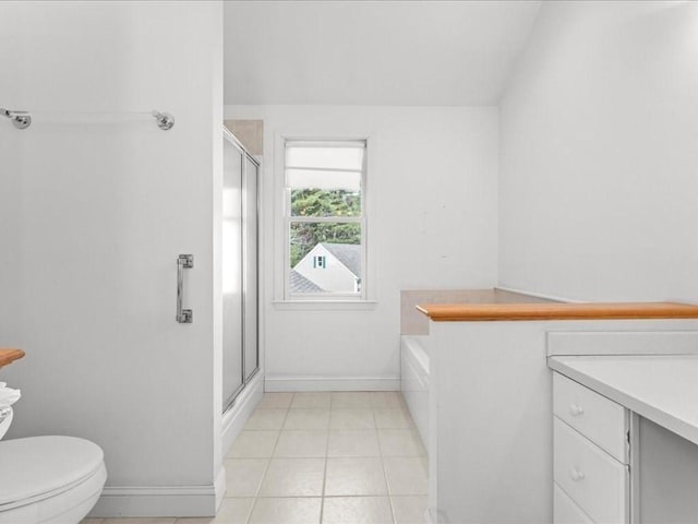 bathroom with vanity, baseboards, a stall shower, tile patterned flooring, and toilet