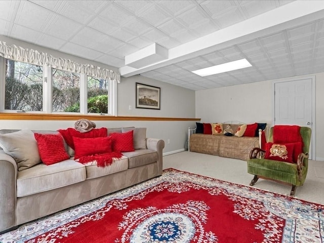 carpeted living area with baseboards