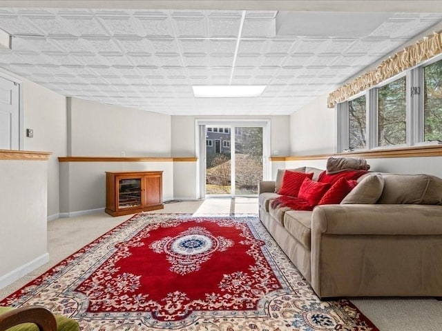 carpeted living room featuring baseboards