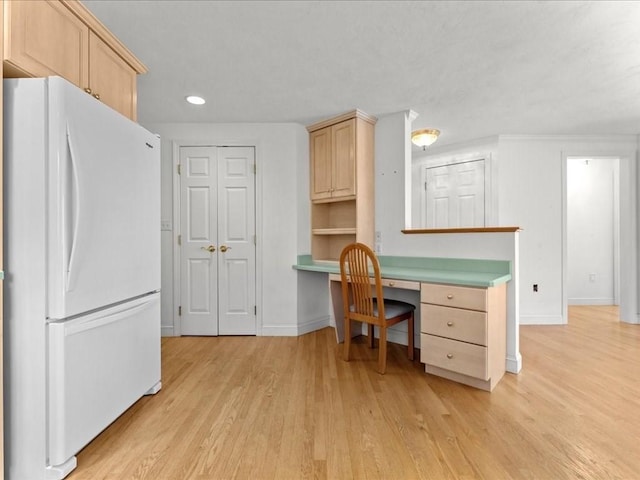 kitchen featuring light wood-style flooring, light brown cabinets, freestanding refrigerator, recessed lighting, and baseboards