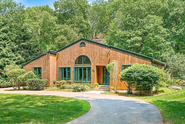 75 Winter St, Hopkinton, MA 01748 - view of front of property featuring a chimney, curved driveway, and a front lawn