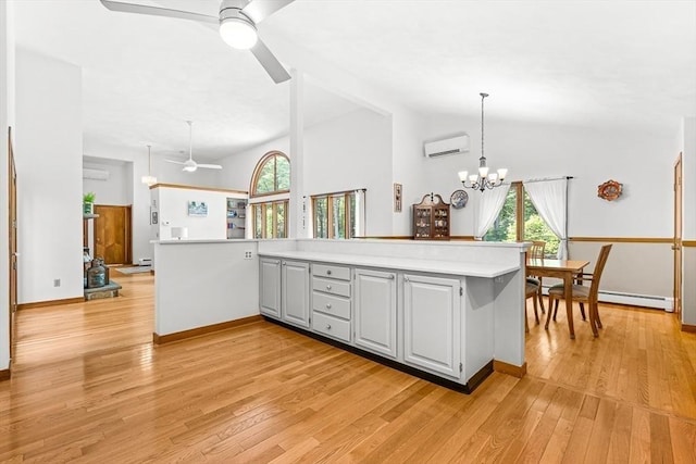 75 Winter St, Hopkinton, MA 01748 - kitchen featuring ceiling fan, a wall unit AC, lofted ceiling, healthy amount of natural light, and light countertops