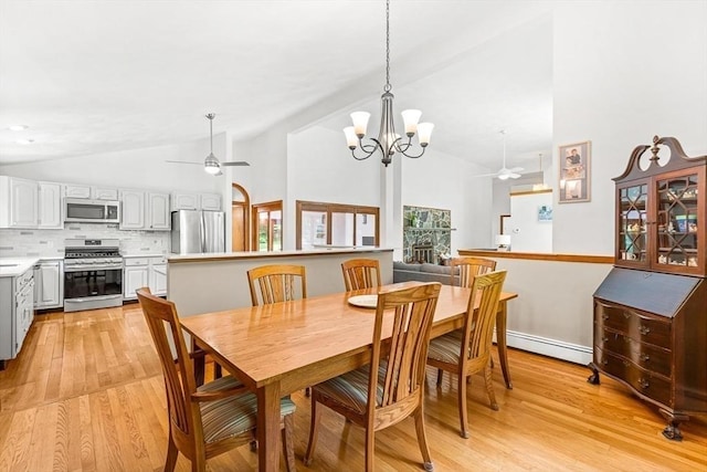 75 Winter St, Hopkinton, MA 01748 - dining area featuring a ceiling fan, baseboard heating, light wood-style flooring, a chandelier, and high vaulted ceiling