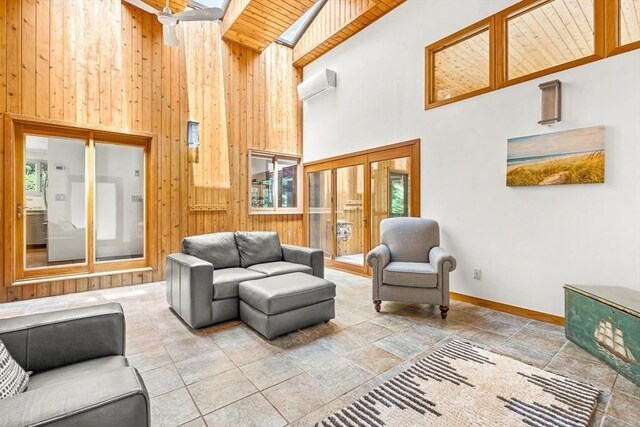 75 Winter St, Hopkinton, MA 01748 - living room with a high ceiling, wood walls, stone tile flooring, and a wall mounted AC