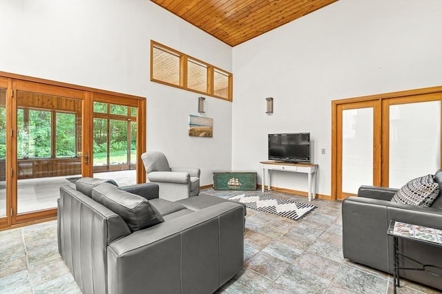 75 Winter St, Hopkinton, MA 01748 - living area featuring high vaulted ceiling, wooden ceiling, and light stone finish flooring