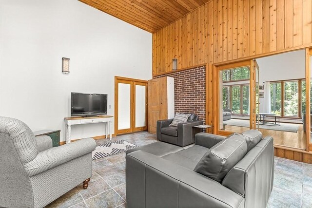 75 Winter St, Hopkinton, MA 01748 - living room with high vaulted ceiling, wooden ceiling, wooden walls, french doors, and stone finish floors