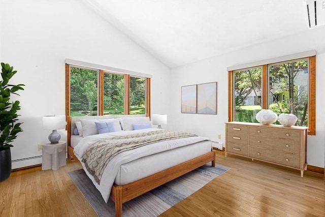 75 Winter St, Hopkinton, MA 01748 - bedroom featuring light wood-type flooring, a baseboard radiator, a baseboard heating unit, and high vaulted ceiling
