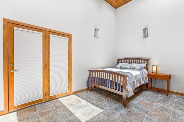 75 Winter St, Hopkinton, MA 01748 - bedroom with stone finish flooring, access to exterior, and vaulted ceiling