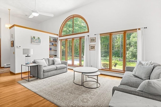 75 Winter St, Hopkinton, MA 01748 - living area featuring a baseboard radiator, a baseboard heating unit, healthy amount of natural light, high vaulted ceiling, and wood finished floors