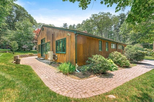 75 Winter St, Hopkinton, MA 01748 - view of property exterior featuring a lawn and a cooling unit