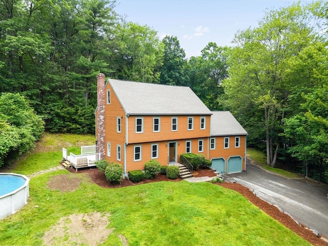 7 Evergreen Cir, Sterling, MA 01564 - colonial house with a chimney, a garage, asphalt driveway, and a front yard
