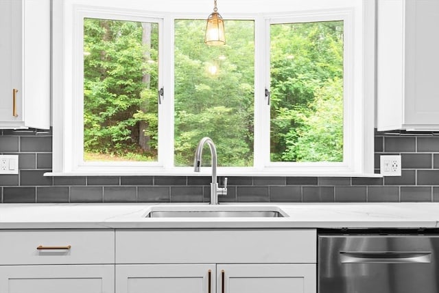 7 Evergreen Cir, Sterling, MA 01564 - kitchen with stainless steel dishwasher, white cabinetry, decorative backsplash, and hanging light fixtures