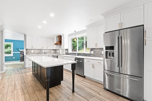 7 Evergreen Cir, Sterling, MA 01564 - kitchen with appliances with stainless steel finishes, wall chimney exhaust hood, decorative backsplash, white cabinetry, and recessed lighting