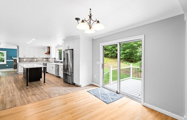 7 Evergreen Cir, Sterling, MA 01564 - kitchen with appliances with stainless steel finishes, light countertops, plenty of natural light, and ornamental molding