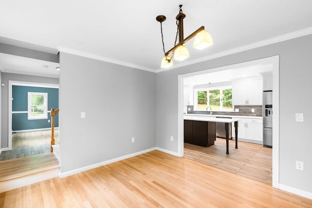 7 Evergreen Cir, Sterling, MA 01564 - unfurnished dining area featuring crown molding, plenty of natural light, and light wood-type flooring