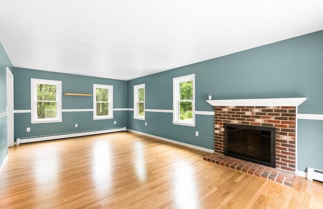 7 Evergreen Cir, Sterling, MA 01564 - unfurnished living room with a baseboard heating unit, a fireplace, and wood finished floors