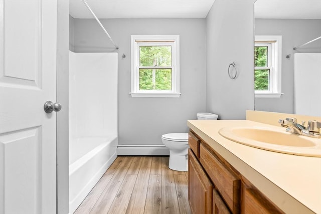 7 Evergreen Cir, Sterling, MA 01564 - full bath with a baseboard radiator, vanity, wood finished floors, and shower / bathtub combination