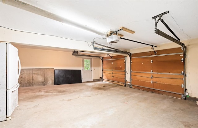 7 Evergreen Cir, Sterling, MA 01564 - garage featuring freestanding refrigerator and a garage door opener