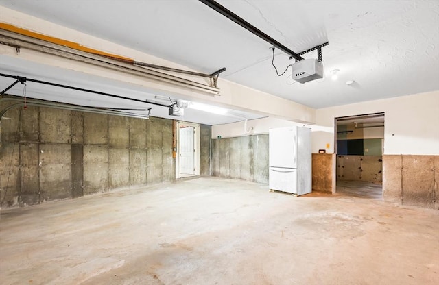 7 Evergreen Cir, Sterling, MA 01564 - garage featuring freestanding refrigerator and a garage door opener