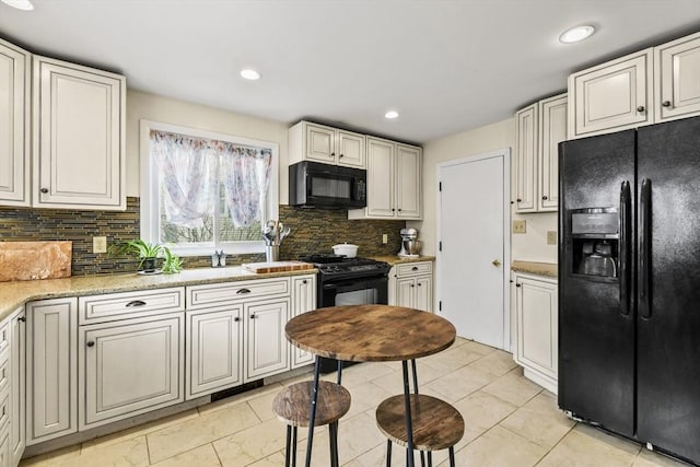127 Carson Ave, Dalton, MA 01226 - kitchen with black appliances, backsplash, recessed lighting, and light stone counters