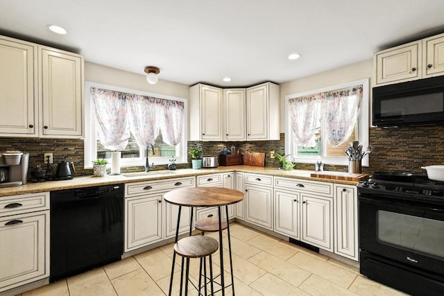 127 Carson Ave, Dalton, MA 01226 - kitchen with black appliances, a sink, backsplash, light countertops, and recessed lighting
