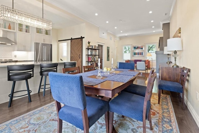 125 Heath St, Somerville, MA 02145 - dining area featuring a barn door, plenty of natural light, dark wood finished floors, crown molding, and recessed lighting