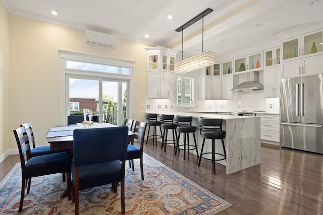 125 Heath St, Somerville, MA 02145 - dining area featuring ornamental molding, a wall mounted air conditioner, dark wood-type flooring, and recessed lighting