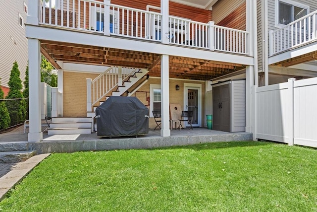 125 Heath St, Somerville, MA 02145 - rear view of property featuring brick siding and a patio area