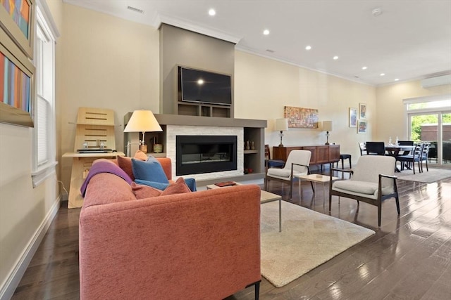 125 Heath St, Somerville, MA 02145 - living room featuring crown molding, a glass covered fireplace, recessed lighting, and dark wood-type flooring