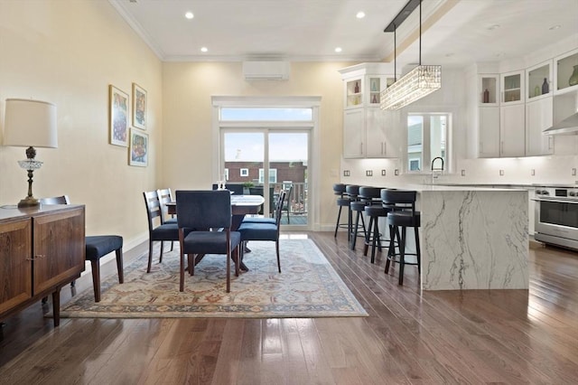 125 Heath St, Somerville, MA 02145 - dining space featuring dark wood-type flooring, a wall mounted AC, ornamental molding, recessed lighting, and a chandelier