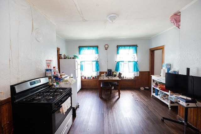 kitchen with ornamental molding, dark hardwood / wood-style flooring, white refrigerator, and stainless steel range with gas stovetop