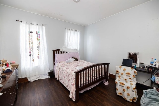 bedroom featuring dark wood-type flooring and multiple windows