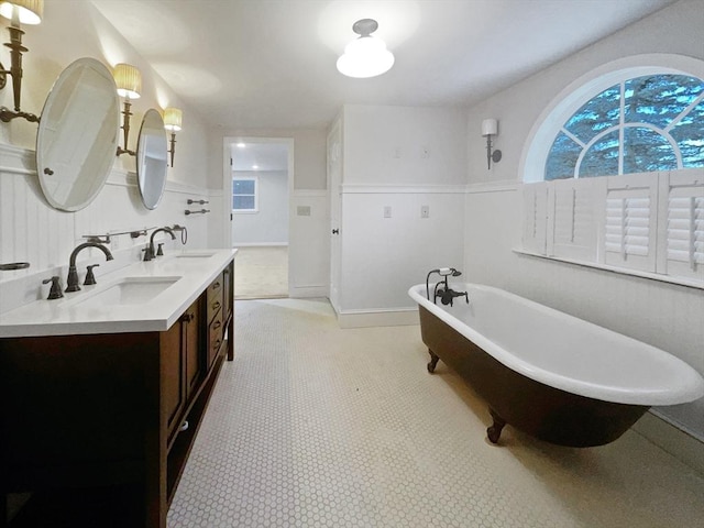 bathroom featuring a tub to relax in and vanity