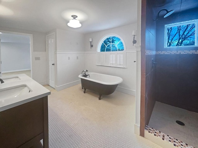 bathroom featuring tile patterned flooring, shower with separate bathtub, and vanity