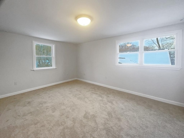 unfurnished room with light colored carpet