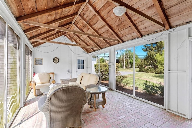 sunroom / solarium featuring vaulted ceiling with beams and wooden ceiling