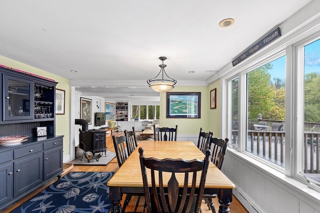 dining area with light wood-type flooring, a wealth of natural light, and baseboard heating