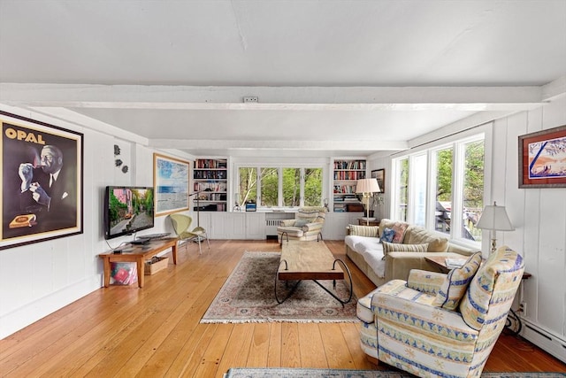 living room featuring hardwood / wood-style flooring, a baseboard radiator, plenty of natural light, and beamed ceiling