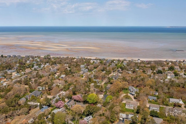 aerial view at dusk featuring a water view