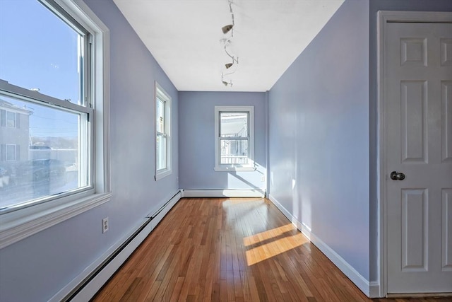 entryway featuring a baseboard heating unit and hardwood / wood-style floors