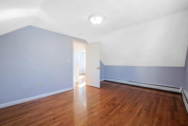 bonus room featuring hardwood / wood-style flooring, vaulted ceiling, and baseboard heating