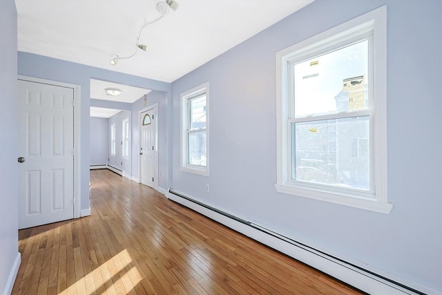 interior space featuring light wood-type flooring and baseboard heating